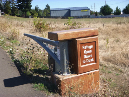 Sign posted on entrance gate - “Refuge Open Dawn to Dusk” Sign posted on entrance gate - “Refuge Open Dawn to Dusk”